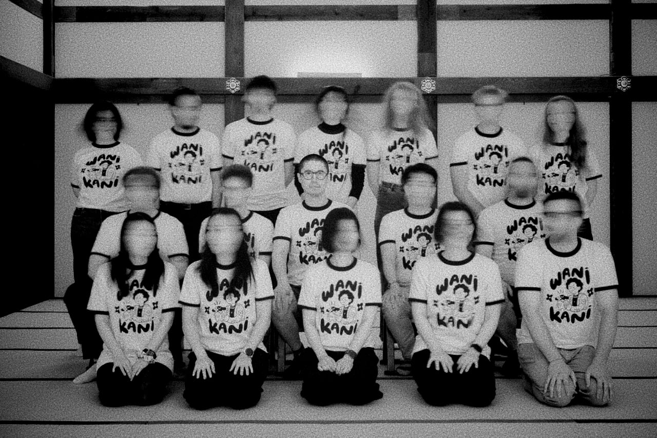 A long-exposure group photo where everyone shook their head, blurring their faces into ghosts
